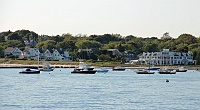  The Kennedy Compound in Hyannis Port.  The flag-draped white-columned house on the far right is the McCarthy residence.  Just behind McCarthy's residence and to the left is JFK's home.  The original Kennedy residence, later inhabited by Sen Ted Kennedy, is in the foreground on the left.  RFK's house lies behind and to the left.