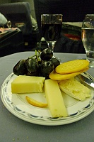  Black grapes, crackers, and assortment of cheeses with port wine