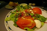  Romaine and mesclun salad mix with hot house tomatoes, mozzarella cheese, crispy terra sticks, and champagne vinaigrette