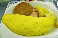  Swiss cheese omelette with potato gratin, grilled smoked pork loin, turkey sausage patty and sauteed button mushrooms