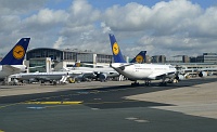  Taxiing Lufthansa A340 aside a parked Lufthansa jet with retro livery