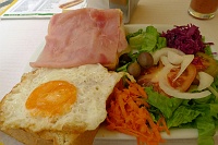  Open-faced ham and egg sandwich with salad