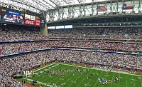  Texans enter the field just before kickoff.
