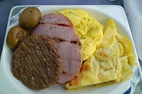  First Class Breakfast: turkey sausage patty, ham steak, egg omelette, and potatoes au gratin