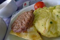  Scrambled eggs with turkey sausage, potatos au gratin, cherry tomatoes, and button mushrooms