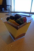  Mango mousse from Tintoretto Bakery with chocolate, fresh sliced mango, raspberry, blackberry, and blueberry