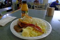  Breakfast at IAH Terminal B: Scrambled eggs, grits, bacon, sausage, buttermilk biscuit, hashbrowns, and orange juice