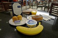  Breakfast, IAH Terminal E United Club: Blueberry muffin, lemon poppyseed muffin, raisin bagel with cream cheese, blueberry yogurt, banana, and orange juice