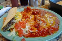  Lunch at Los Cuates - Beef taco, cheese enchilada, and carne adovada. Served with refried beans and rice.