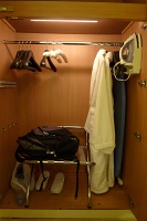  Robe, slippers, clothes hangars, ironing board, and iron