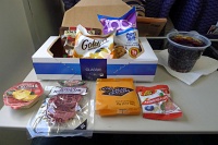  Choice Snackbox: Snyder's Pretzels, Goldfish, 100 Cal Chips Ahoy, Cheddar Gourmet Cheese Spread, Hormel Homeland Hard Salami, Jacob's Cream Crackers, Jelly Belly Assorted Flavors, and Coca-Cola