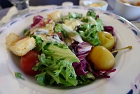  Fresh seasonal greens with tomato, dried cherries, mini fruit and croutons with tropical fruit dressing