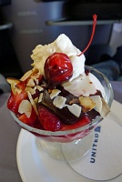  Ice cream sundae with strawberries, hot fudge, whipped cream, nuts, and cherry