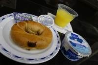 Breakfast at IAH United Club: Raisin bagel with jelly and cream cheese, blueberry yogurt, and orange juice