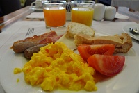  Scrambled eggs, sausage, bacon, fresh tomato, assorted cold cuts and cheese, and almond cake