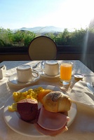  Assorted cold cuts, bread, scrambled eggs, peach, and chocolate cake