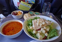  Chicken Caesar Salad with tomato soup, roll, and fruit salad