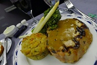  Grilled pork chop with green peppercorn sauce, shiitake mushroom bread pudding, white asparagus, and broccolini