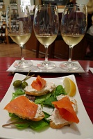  Smoked salmon rolls served with crabmeat and crispy crostini at Vino Volo, Seattle Airport