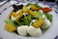  Fresh seasonal greens with roasted tomatoes, Kalamata olives, baby mozzarella, croutons and blue cheese dressing