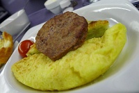  Omelette, sausage, potatoes au gratin, and roasted cherry tomato