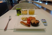  SkyTeam Lounge: Sausage, cherry tomatoes, potatoes, beans, muffin, gingerale, and pineapple juice