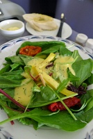  Fresh seasonal greens with sun-dried tomato, bell pepper, dried cranberries & croutons, and creamy passion fruit dressing