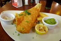  Fish & Chips: Prime fillet of haddock, cooked in beer batter - served with chips, mushy peas, tartare sauce and lemon