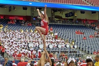  UH cheerleader with Cougar marching band in the background