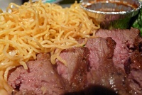  Medium beef steak with noodles and broccoli