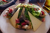  Alcachofas Estofadas: Braised artichokes with serrano ham, sweet pea salad, walnut dressing & manchego cheese