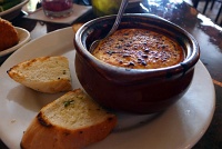  Queso de Cabra Montanes: Baked goat cheese in tomato basil sauce with toasted garlic bread
