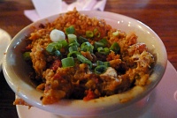  Rabbit & Sausage Jambalaya at Coop's Place: A traditional Creole rice dish, simmared with tomatoes, onion, bell pepper, local seasonings, boneless rabbit, and smoked pork sausage.