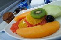 Sliced seasonal fruit (kiwi, orange, grapefruit, cantaloupe, honeydew melon, and blackberry) and blueberry muffin - Executive First Class, Air Canada A330