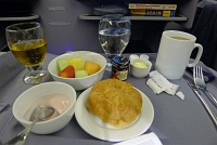  BusinessFirst breakfast with yogurt, croissant, fresh fruit appetizer, apple juice, and hot tea - IAH-FRA