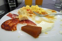  Hotel Gran Melia Colon breakfast buffet, Sevilla: Chorizo, cured ham, scrambled eggs, baked beans, quince, and fresh cheese