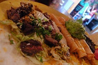  Carne taco and three rolled chicken tacos with guacamole, served with Mexican rice & black beans at Fred's Mexican Cafe