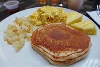  Pancakes and syrup with fried potatoes, scrambled eggs, and pineapple at Embassy Suites LAX North